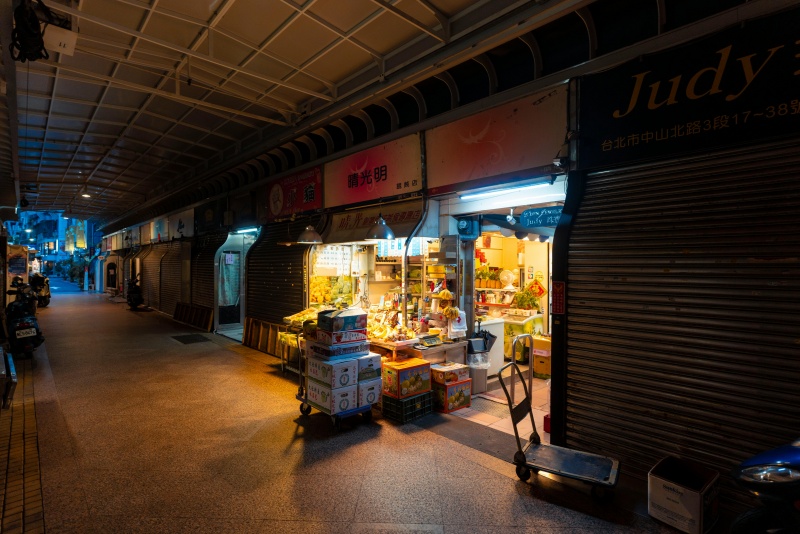 Retail buyer examining fabric and packaging colors under different LED lighting samples during product selection